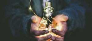 man holding incandescent bulb